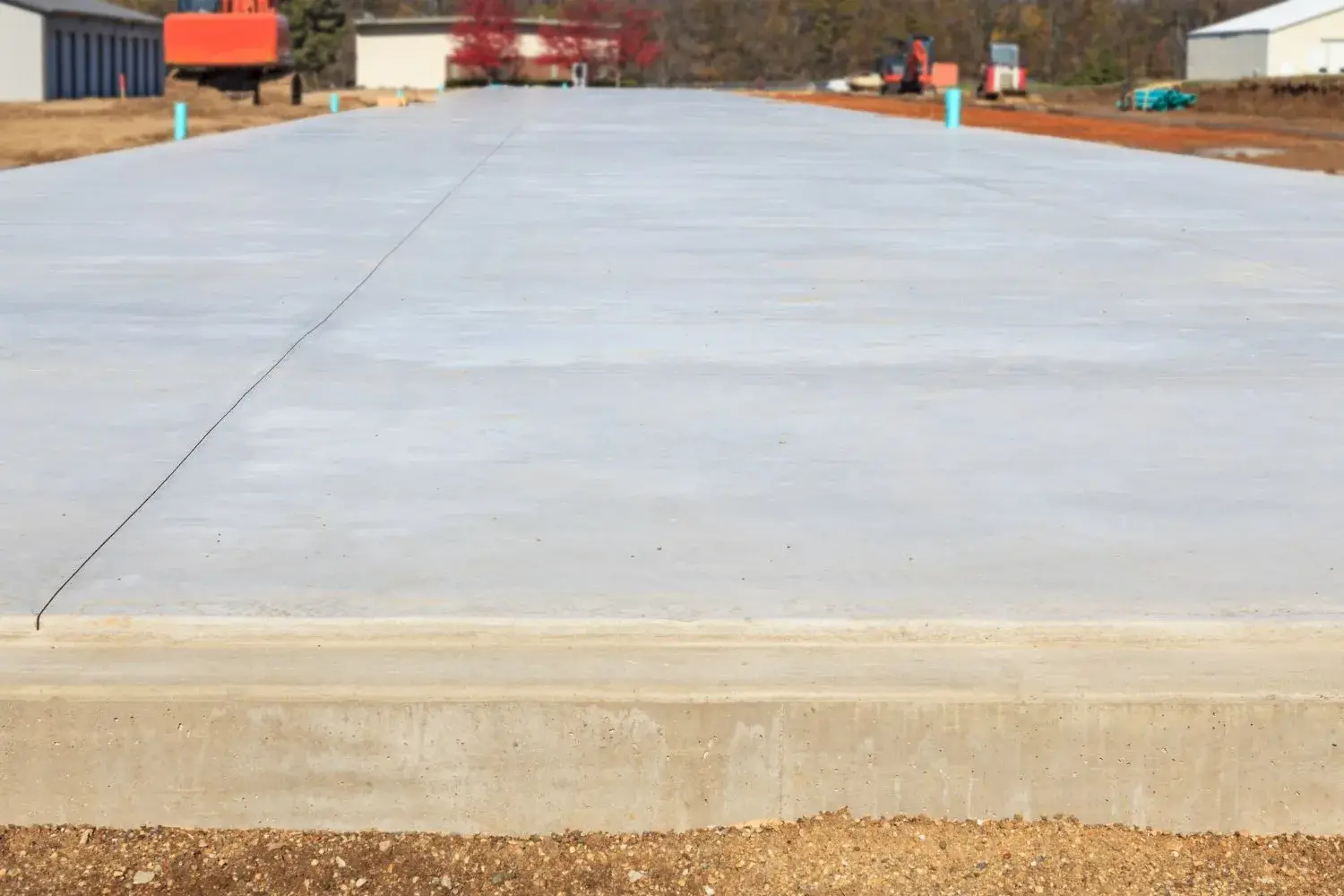 Freshly poured level concrete slab ready for building
